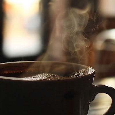 Steaming Hot Coffee in Morning Light - A close-up of a steaming hot cup of coffee, with soft morning light filtering through a window in the background. The steam rises gently, creating a cozy and inviting atmosphere perfect for a relaxing morning.