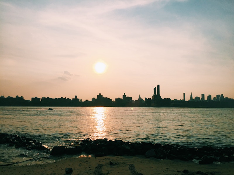 Photo: Sunset Overlooking Cityscape and Beach