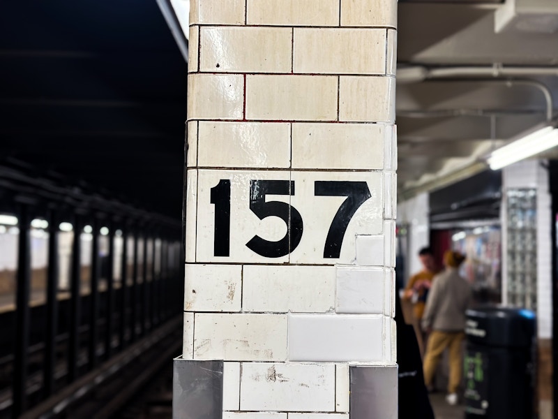 Photo: A white brick column at a subway station with black numbers