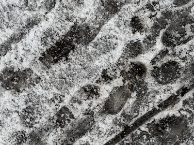 Shoe Prints in Snow - A close-up of a shoe print in snow and ice