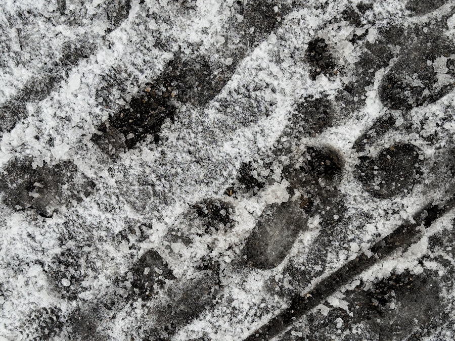 Photo: A close-up of a shoe print in snow and ice