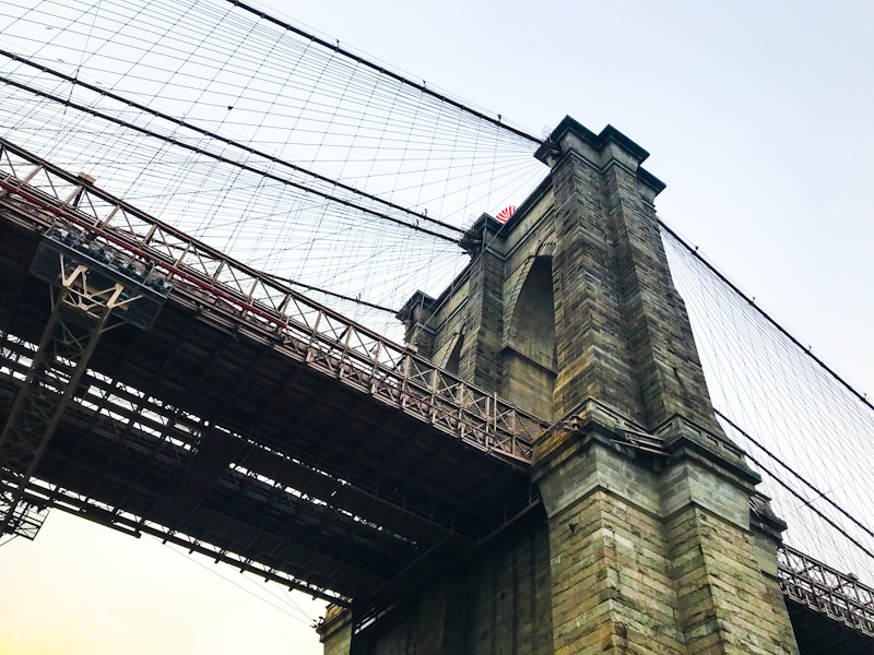 Photo: Looking up perspective at the Brooklyn Bridge with wire mesh 