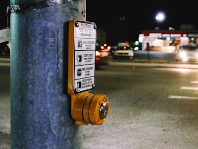 Street Crossing - A close up of a pedestrian button in front of a street