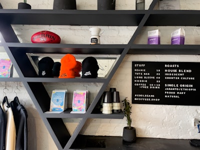 Coffee Shop Interior - A menu and shelf in a coffee shop with various items on it