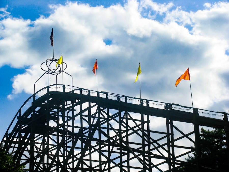 Photo: Rollercoaster Silhouette Under Blue Sky and Clouds