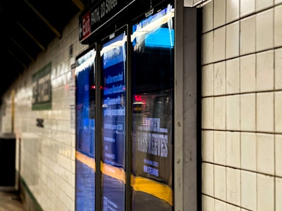 Screens in Subway Station - A close up of a screen on a wall in a subway station