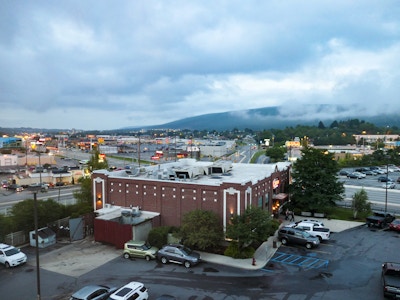 Buildings and Mountains Over Highway