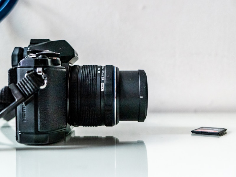 Photo: A camera and memory card on a white desk