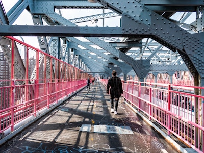 People Walking on Bridge - A man walking on a bridge