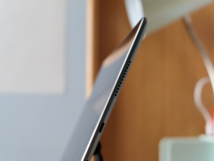 Photo: A close up of a tablet in focus at a blurred desk