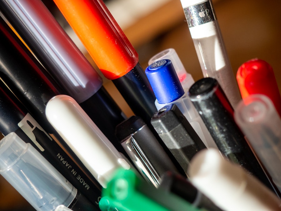 Photo: A group of colorful pens in a container