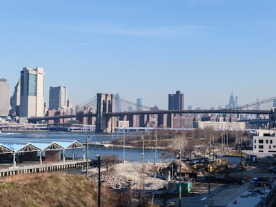 City Buildings and Bridge - A bridge over water with buildings and city skyline in the background