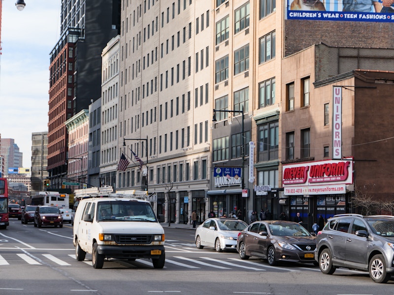 Photo: A street with cars and buildings in a city