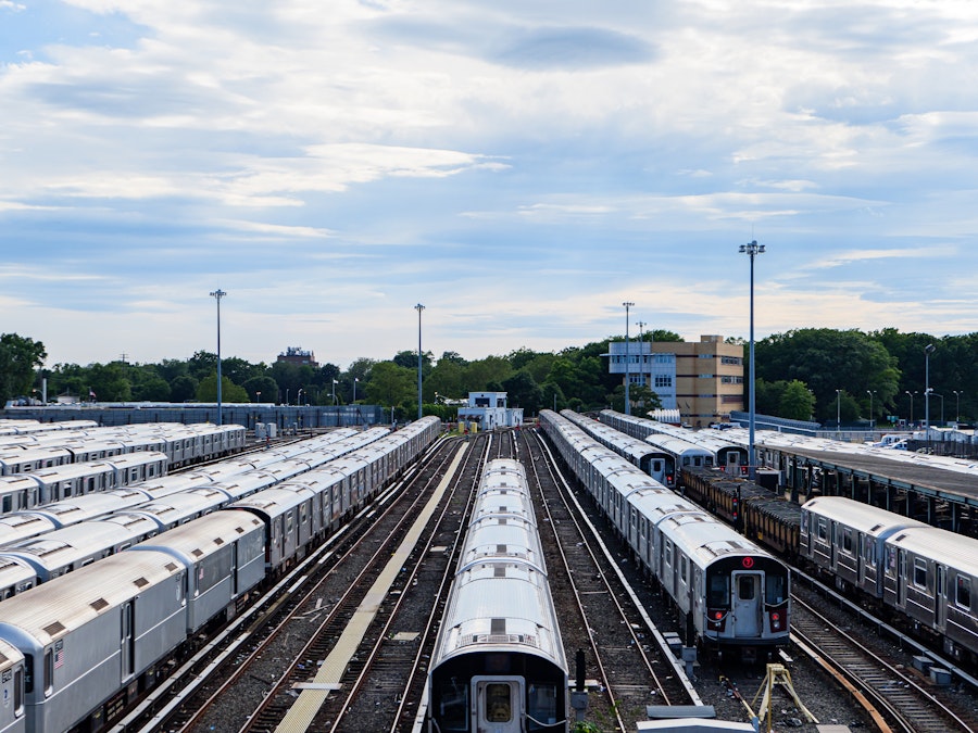 Photo: A group of subway trains on tracks at a yard