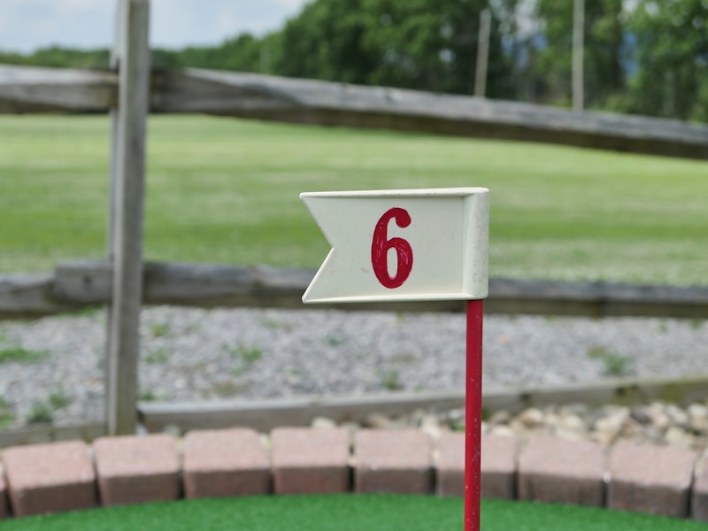 Photo: A flag on a golf course with a red number 6