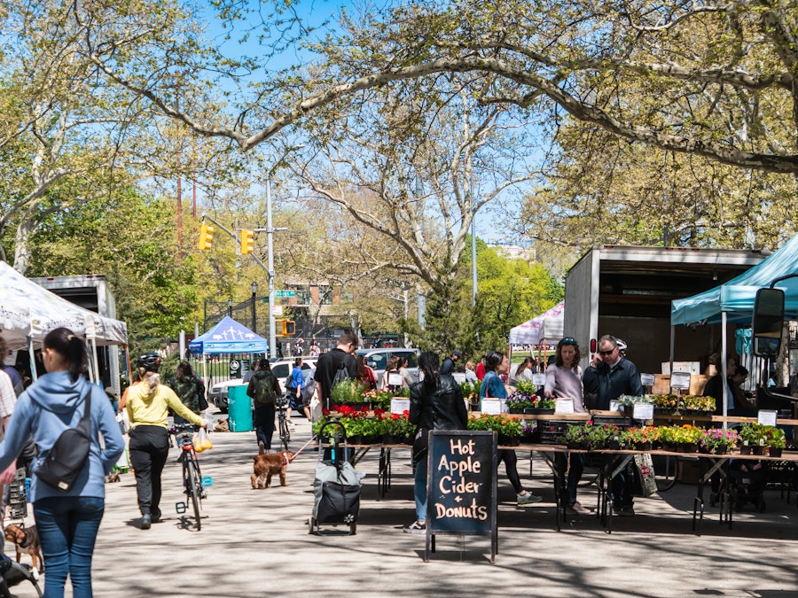 Photo: A group of people walking at a farmers market