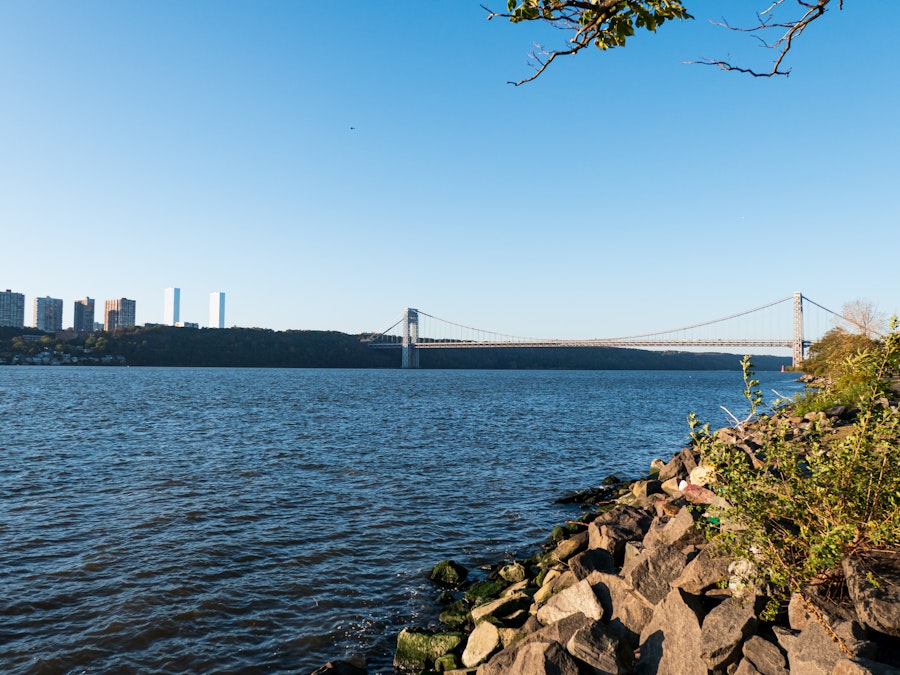 Photo: A body of water with a bridge and a city in the background