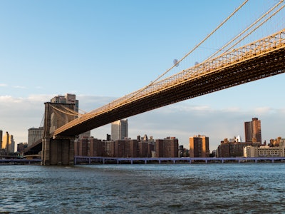 City Bridge Over Ocean - A bridge over water with a city in the background