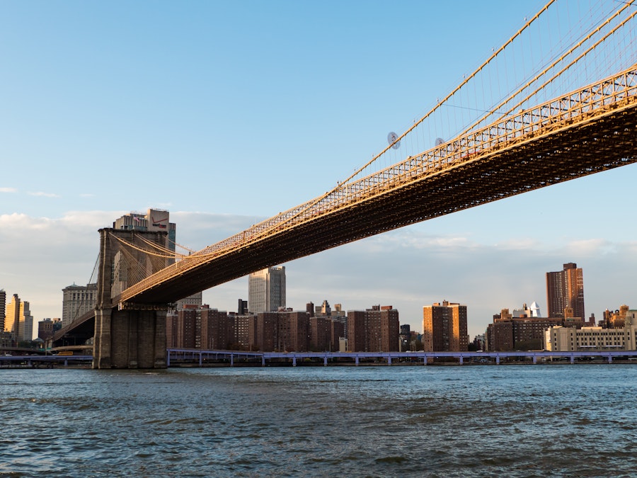 Photo: A bridge over water with a city in the background