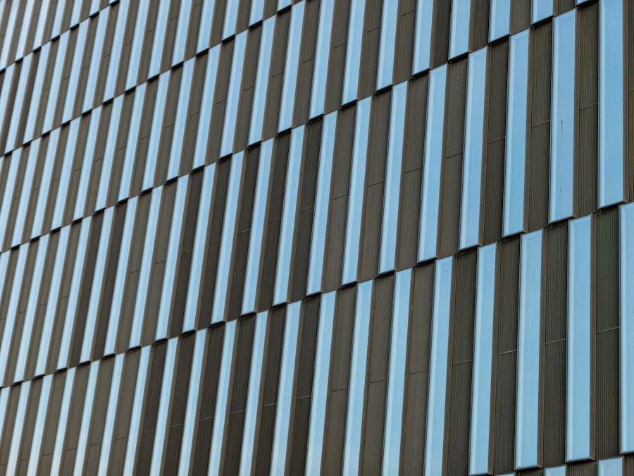 Photo: A close up of a geometric building with long rectangular windows 