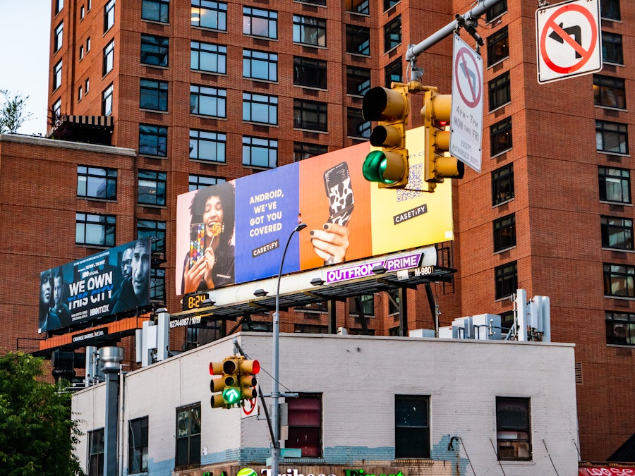 Photo: Billboards on top of buildings in a city
