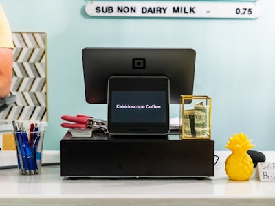 Register on Front Counter at Coffee Shop - A register on a counter at a coffee shop 