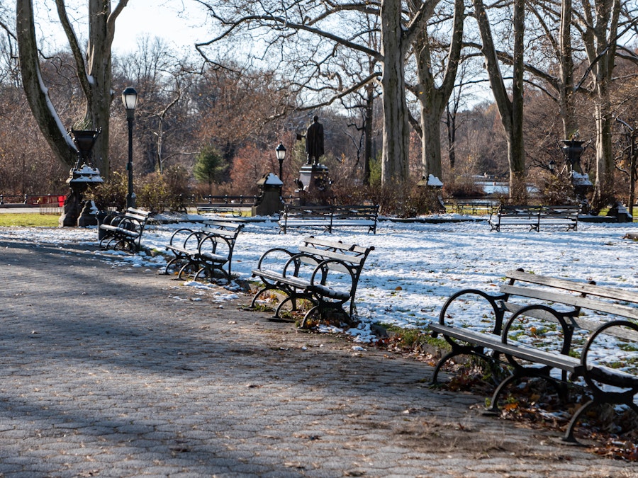 Photo: A park with benches and snow on the ground