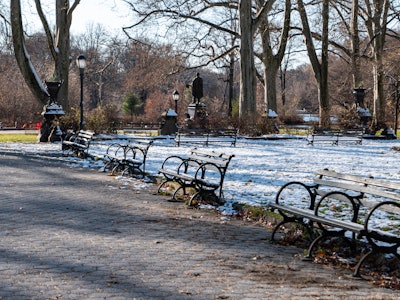Snow Covered Park Benches - A park with benches and snow on the ground