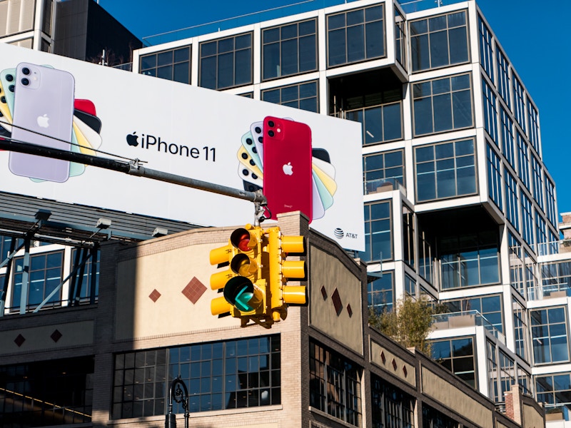 Photo: A traffic light in front of several buildings with a billboard