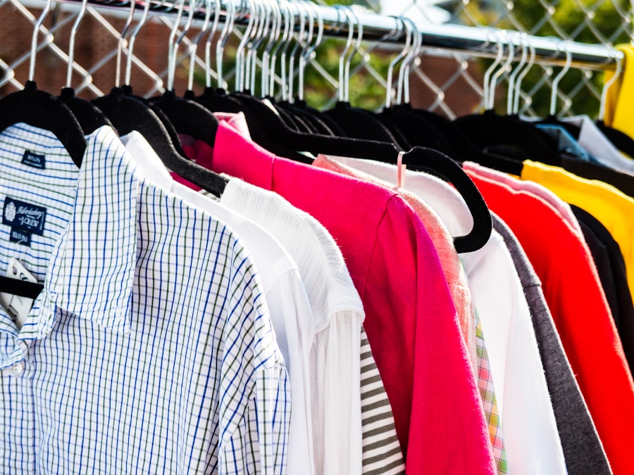 Photo: A group of shirts on a metal clothing rack