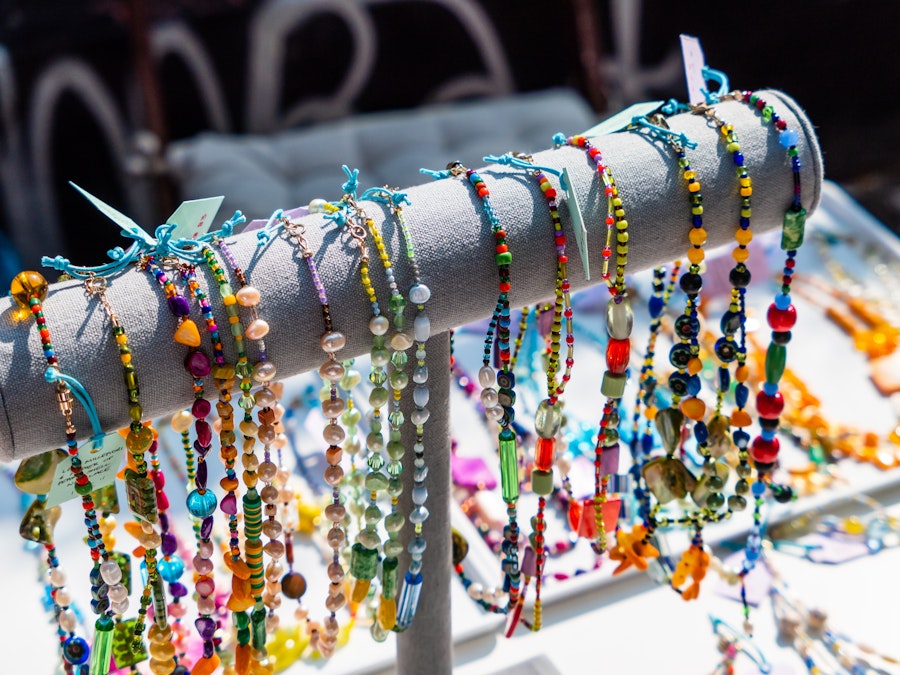 Photo: A group of colorful necklaces and beads on a rack