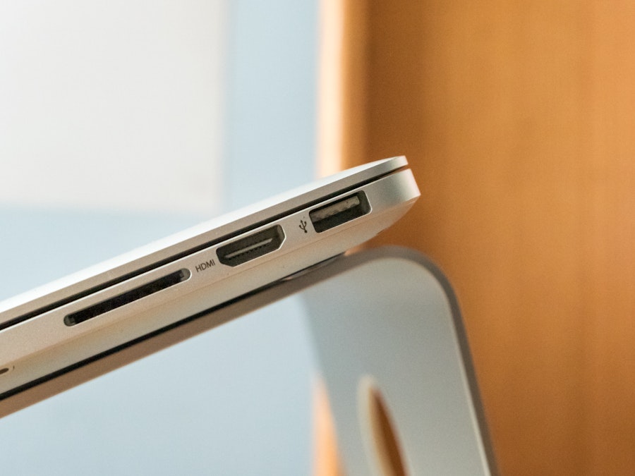Photo: A close up of a laptop on a silver metal stand 