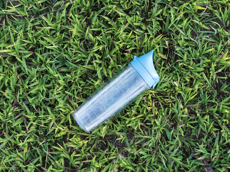 Photo: A hard plastic water bottle on grass in a field 
