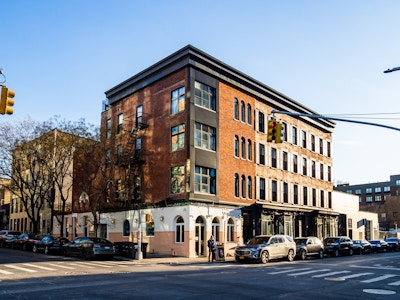 Brooklyn Street, Restaurant, and Buildings - Buildings on a city street with cars parked on the side