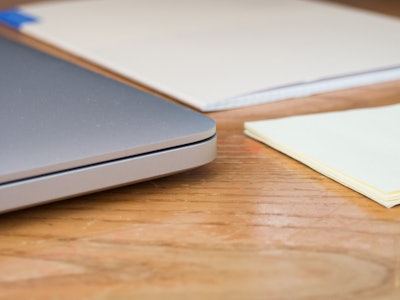 Laptop and Notebook on Wood Desk