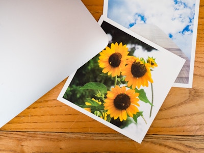 Photos Under Laptop on Desk