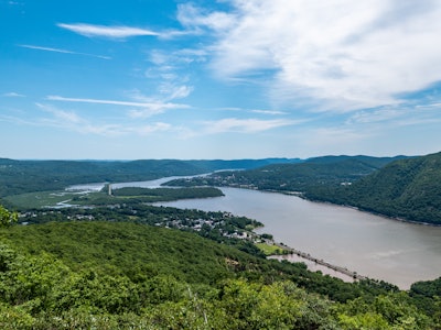 Hudson River and Mountains - A river running through a valley with mountains, trees, and towns 