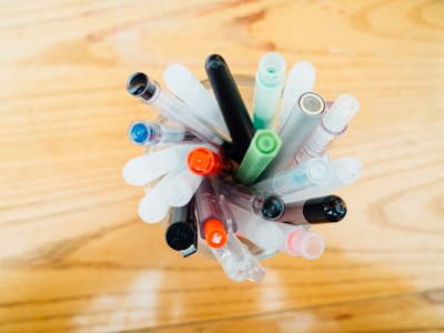 Pens in Cup on Desk