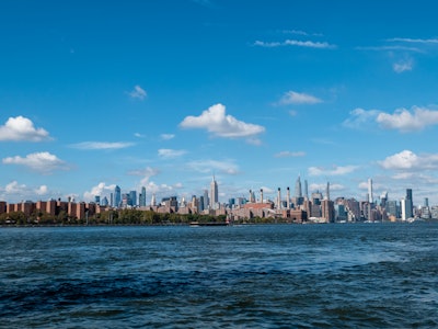 Manhattan Skyline Behind River - A city skyline with a body of water