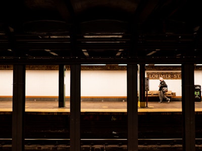 Brooklyn Subway Platform - A person standing on a subway platform