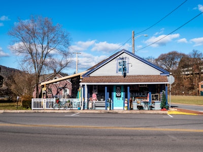 Coffee Shop - A small storefront with a white fence and outside sitting area