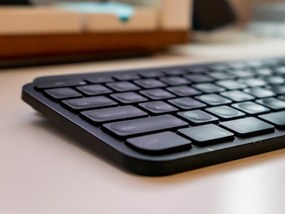 Keyboard on Desk - A black keyboard on a white desk