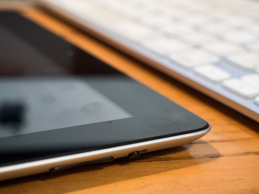 Photo: Tablet and Keyboard on Wooden Desk