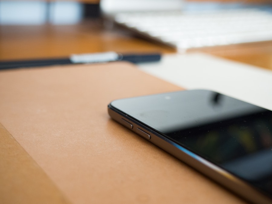 Photo: Phone and Notebook on Desk