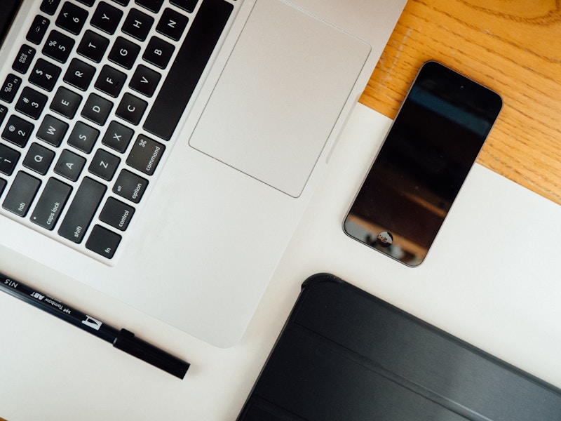 Photo: Laptop, Pen, and Phone on Desk