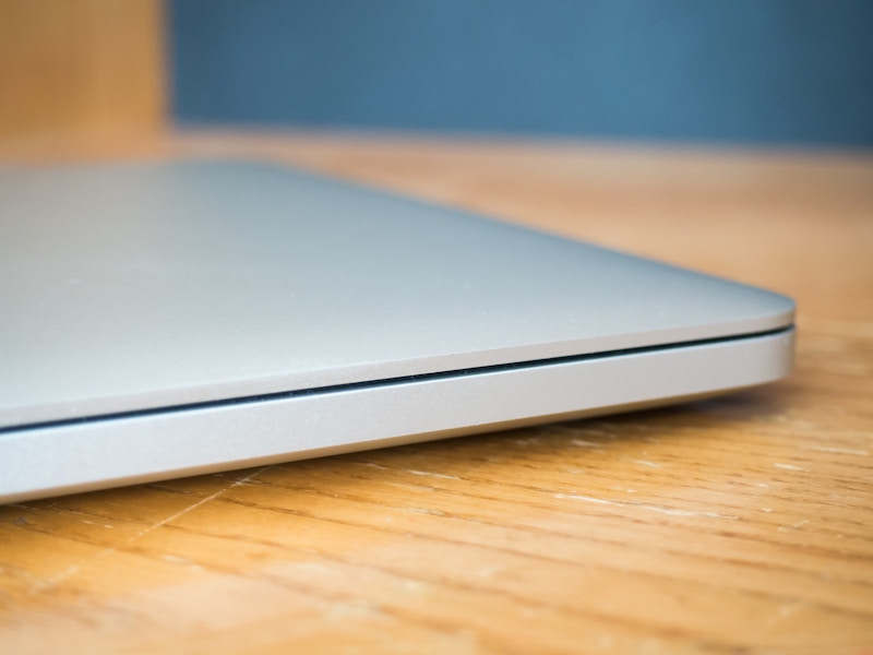 Photo: Closed Laptop on Wooden Desk