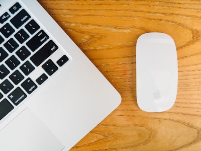 Laptop and Mouse on Wooden Desk