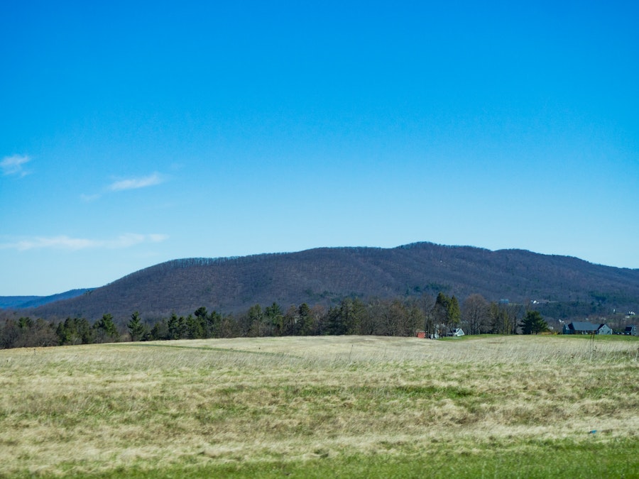 Photo: Landscape Under Blue Sky and Mountains