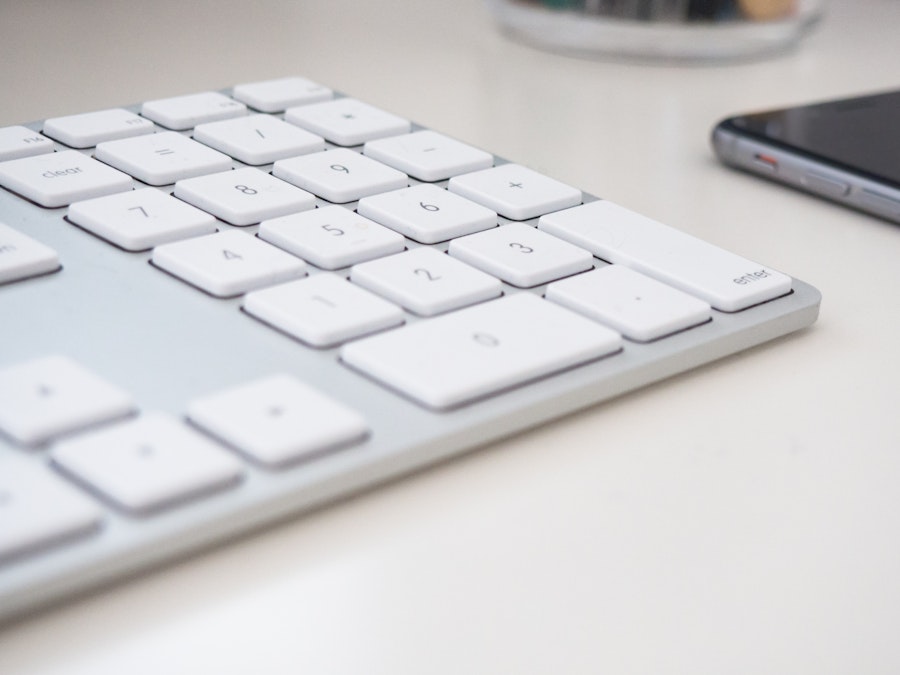 Photo: Keyboard and Phone on White Desk