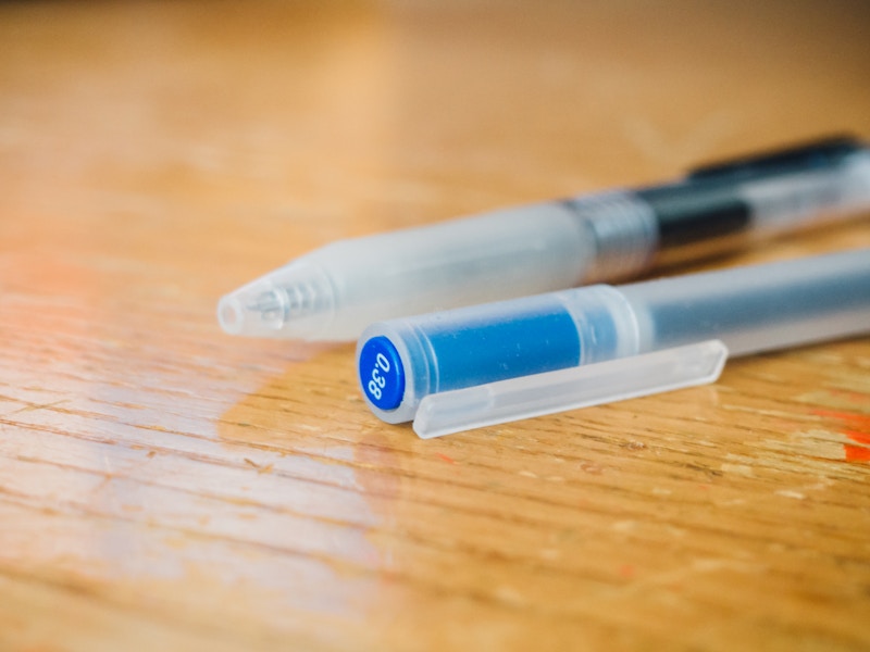 Photo: Blue and Black Pens on Desk